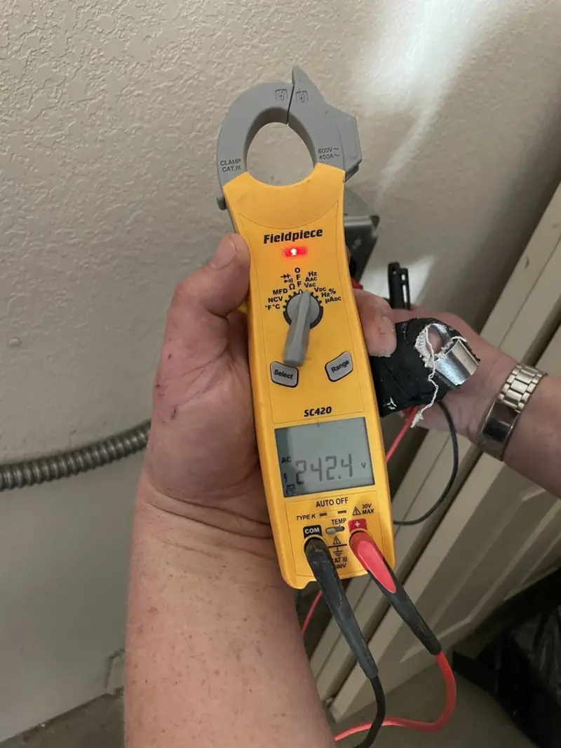 Voltage testing with clamp meter during Electrical Installation Services in Round Lake